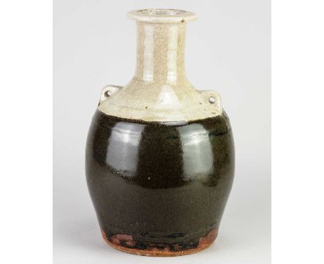 JIM MALONE (born 1946); a lugged stoneware bottle covered in tenmoku breaking to kaki glaze with green ash top, impressed JM 