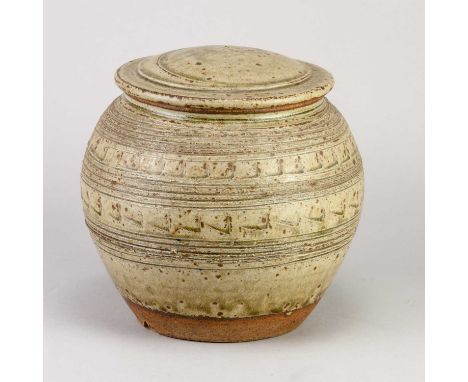 † JIM MALONE (born 1946); a stoneware jar and cover covered in green ash glaze with incised decoration, impressed JM mark, he