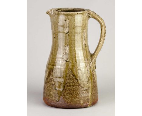 † JIM MALONE (born 1946); a stoneware pitcher partially covered in green ash glaze with incised decoration, incised JM and A 