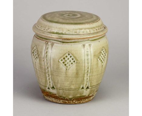 † MIKE DODD (born 1943); a stoneware caddy covered in green pine ash glaze with incised and impressed decoration, impressed M