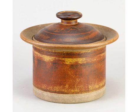 † ROBIN WELCH (1936-2019); a cylindrical stoneware jar and cover decorated with bands of mottled red rust glaze, impressed ma