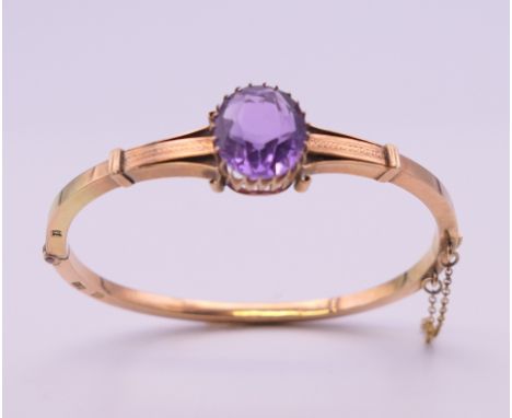 A 19th century Russian 14 ct gold and amethyst bangle. 5.5 cm internal width. 11.5 grammes total weight.