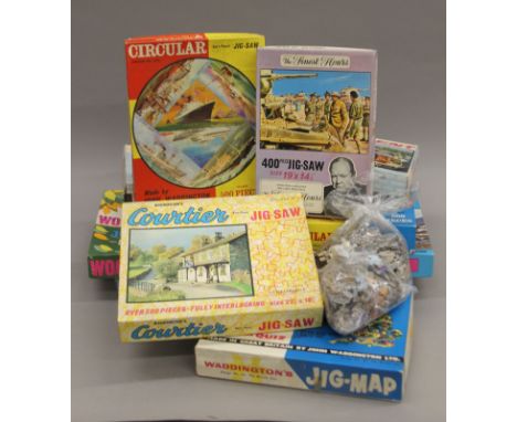 A quantity of vintage jigsaw puzzles, wooden plates, a cuckoo clock and various vintage tins.