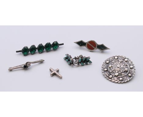 A Scottish stone brooch, silver earrings, two silver bar brooches, a Celtic silver Glasgow brooch and a silver cross. The for