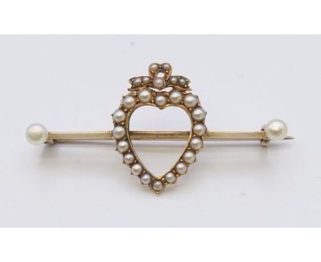 An unmarked gold seed pearl set heart form brooch. 4 cm wide. 4 grammes total weight.