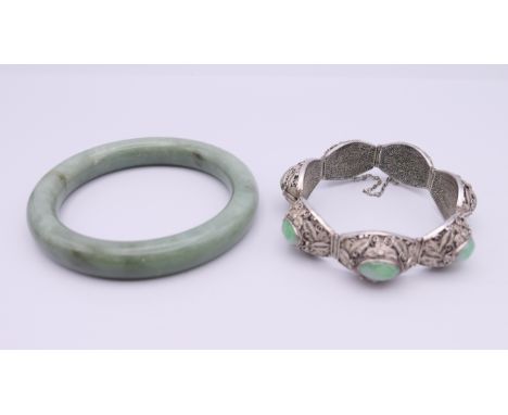 A Chinese silver and jade bracelet, and a bangle. The former approximately 17 cm long.