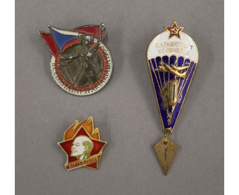 Three Soviet enamel badges, including a 1960 Student Games and the Parachute Regiment.