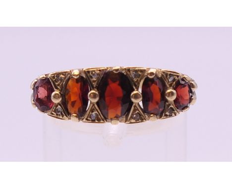 A 9 ct gold garnet and diamond ring. Ring size P. 5.2 grammes total weight.