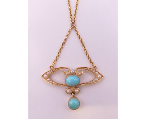 A boxed Art Nouveau 15 ct gold seed pearl and turquoise pendant on chain. The pendant 2.5 cm wide. 4 grammes total weight.