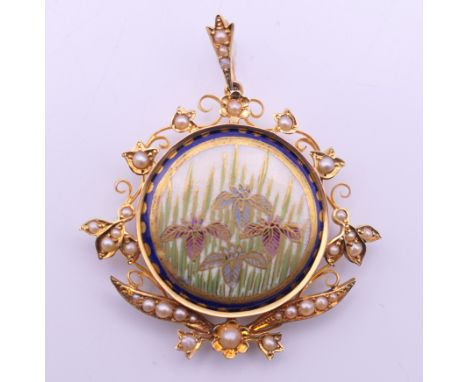 A gold and seed pearl pendant centred with a Satsuma porcelain plaque. 4 cm wide.
