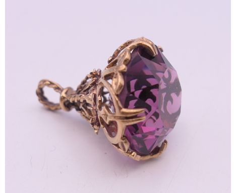 A 9 ct gold and amethyst fob. 2.5 cm high. 7.7 grammes total weight.