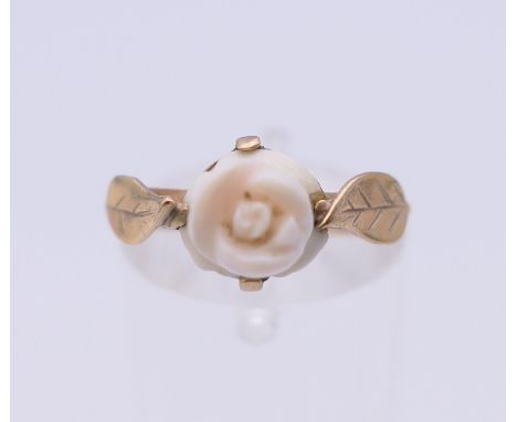 A 9 ct gold and coral florally set ring. Ring size J.