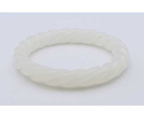 A white jade twist bangle. Approximately 5.5 cm internal diameter.