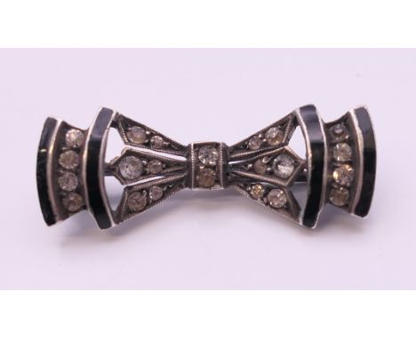 An Art Deco silver black enamel and paste brooch. 3 cm wide.