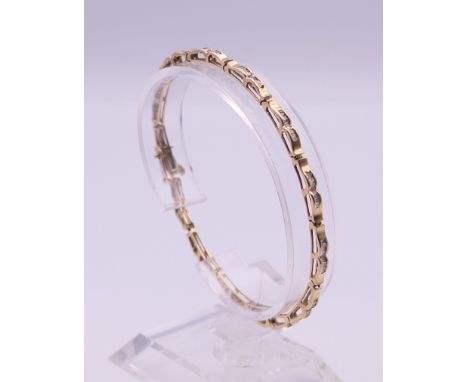 A 10 K gold diamond bracelet (with one link separated). 18.5 cm long. 6.8 grammes total weight.