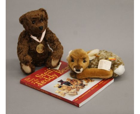 A Steiff 2005 Bear of the Year (28 cm high), a Steiff Dear and a copy of The Story of the Steiff Teddy Bear.