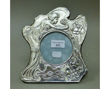 An Art Nouveau style silver photograph frame. 21 cm high.
