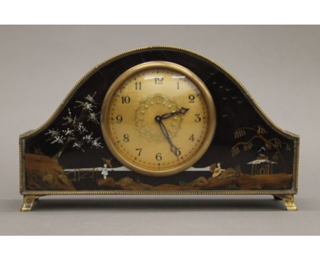 A chinoiserie mantle clock. 24 cm wide.