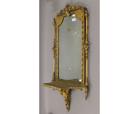 A Victorian gilt framed mirror with integral bracket. 95 cm high.