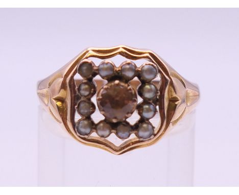 A 15 ct gold Imperial topaz and seed pearl ring, hallmarked 625. Ring size R/S. 4.2 grammes total weight.