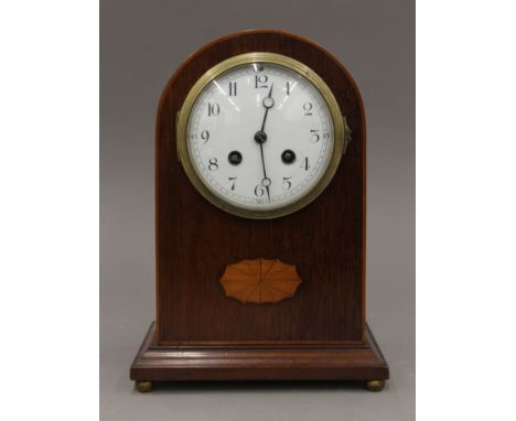 A Victorian inlaid mahogany mantle clock. 25 cm high.