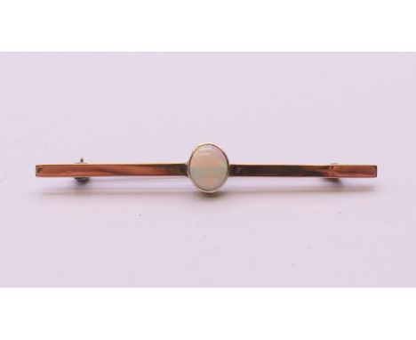 An unmarked 9 ct gold opal brooch. 6.25 cm long. 