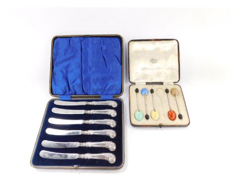 A set of six Edward VII silver pistol handle cake knives, cased, Sheffield 1905, and five silver and enamel coffee spoons, ca