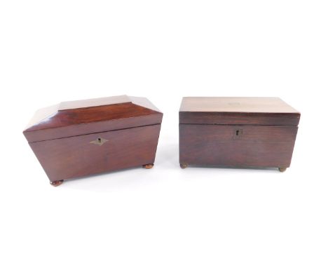 A Regency mahogany tea caddy of sarcophagus form, the hinged lid opening to reveal three compartments, raised on bun feet, 25