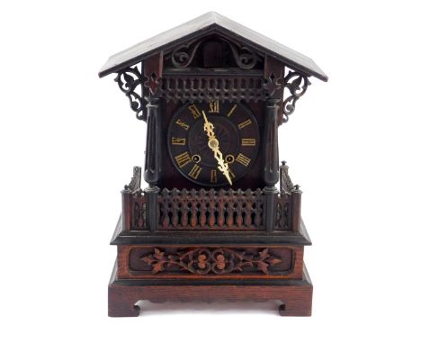 A German late 19thC oak cased cuckoo mantel clock, the circular dial bearing Roman numerals, eight day movement, the case of 
