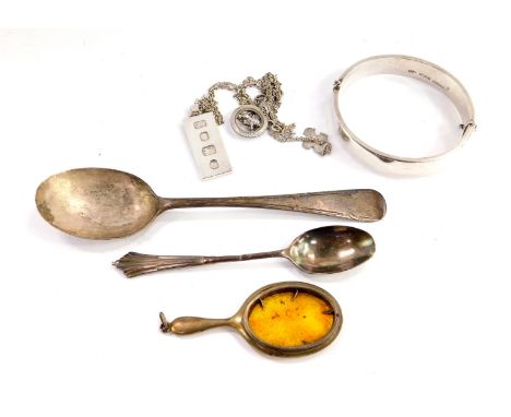 A George V silver spoon, Sheffield 1911, silver coffee spoon, silver bangle with engraved floral and foliate decoration, on a