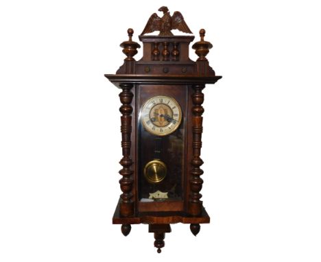 A German late 19thC walnut and oak Vienna wall clock, circular brass dial with enamel chapter ring bearing Roman numerals, ei
