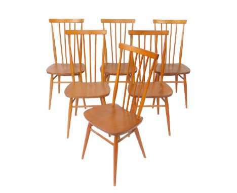 A set of six Ercol beech and elm stick back kitchen chairs, with solid seats, raised on turned legs.