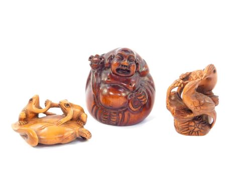 Two Japanese late 20thC carved wooden netsuke, signed, one with two frogs on a lily pad in an arm wrestle, 5cm long, the othe