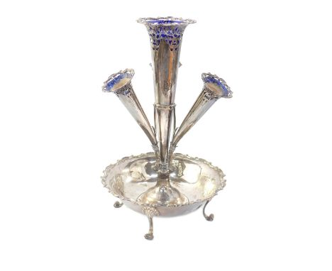 An Edward VII silver epergne, of four trumpet form, with four Bristol Blue glass flower holders, with pierced scrolling folia