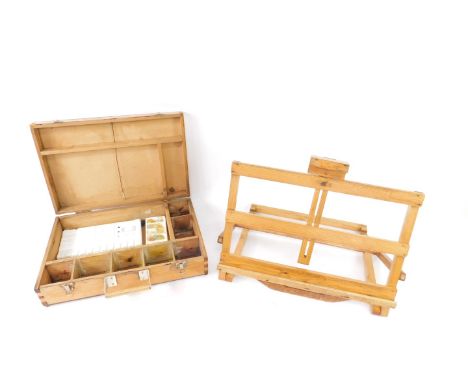 A 1960's artist's pine paint box, 46cm W, 30.5cm D, together with a pine easel, 51.5cm W. (2)