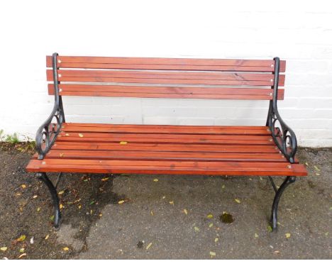 A garden bench with cast metal ends and wooden slats, 120cmW.