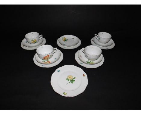 A Herend porcelain part tea service, painted with flowers and floral sprigs, comprising four tea cups, five saucers and six t