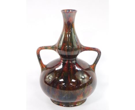 A Burmantofts Christopher Dresser design late 19thC pottery vase, of twin handled baluster form, decorated with running glaze