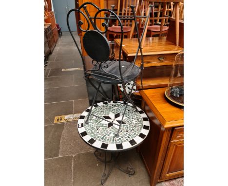 A garden table and 2 metal folding chairs.