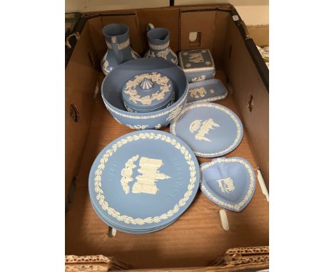 A box of blue and white Wedgwood jasperware including jugs, plates and lidded dishes. 