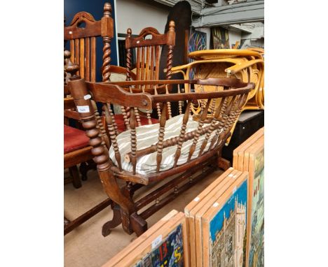 An antique rocking crib with bobbin turned spindles. 
