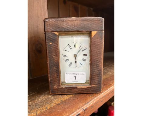 A French brass and glass carriage clock in original box with key.Condition:- wear and rips to box throughout, clock winds, ti