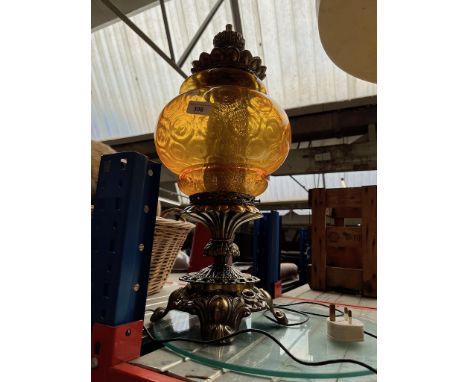 A metal and amber glass ornate table lamp. 