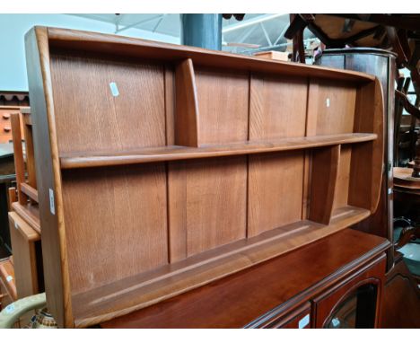 An Ercol 'Golden Dawn' wall mounting plate rack, blue label. 