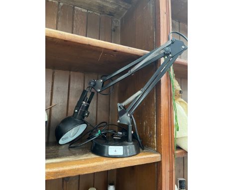 A modern black adjustable anglepoise lamp. 