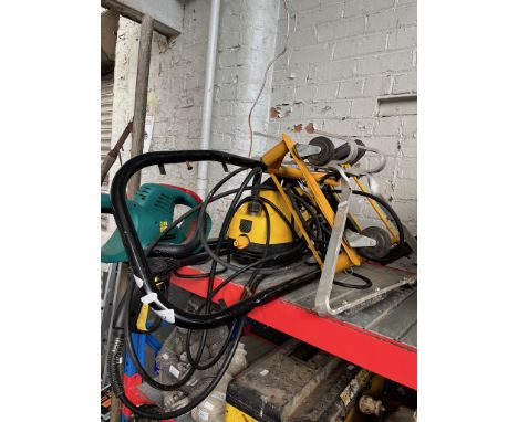 A Bosch electric hedge trimmer, a Wickes pressure washer, a sack truck and a ladder stand off. 