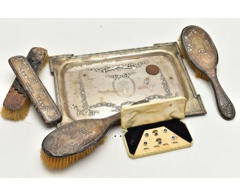 AN EARLY 20TH CENTURY SILVER TRAY AND VANITY PIECES, the tray of a rectangular form, decorated with an embossed floral, bow a