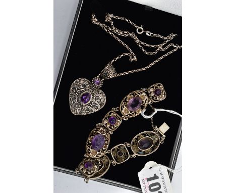 A GEMSET NECKLACE AND BRACELET, the first a large white metal heart shaped pendant with scrolling detail, collet set with two