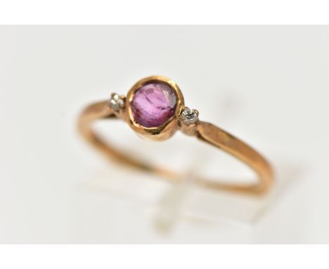 A YELLOW METAL RUBY AND DIAMOND RING, designed with a collet set ruby, flanked with two small round brilliant cut diamonds, l