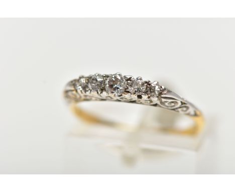 AN 18CT GOLD FIVE STONE DIAMOND RING, set with graduated old cut diamonds and two single cut diamonds, each claw set in a whi